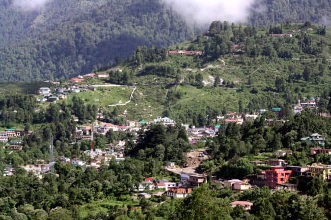Green Himalayan mountains with small village houses