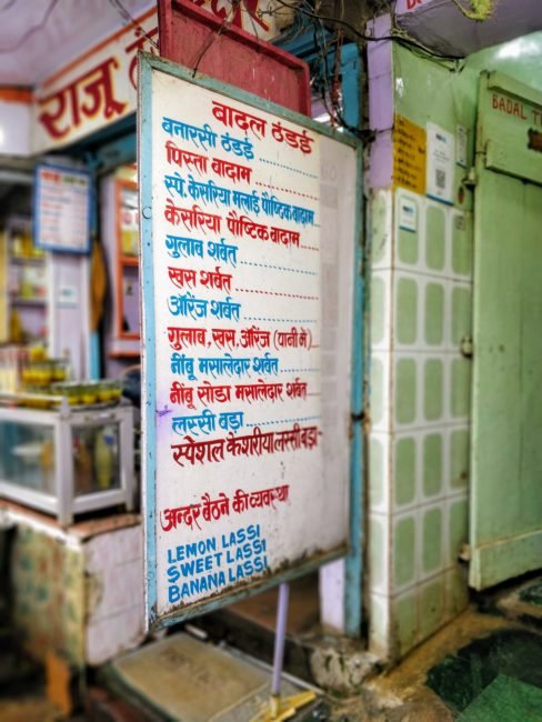 Interior of Badal Thandai showing menu with bhang thandai options and prices in Varanasi