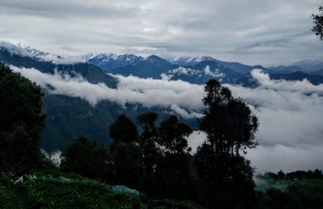 clouds over green Himalayan Mountains in Sarmoli, Munsiyari, Pithoragarh, Uttarakhand