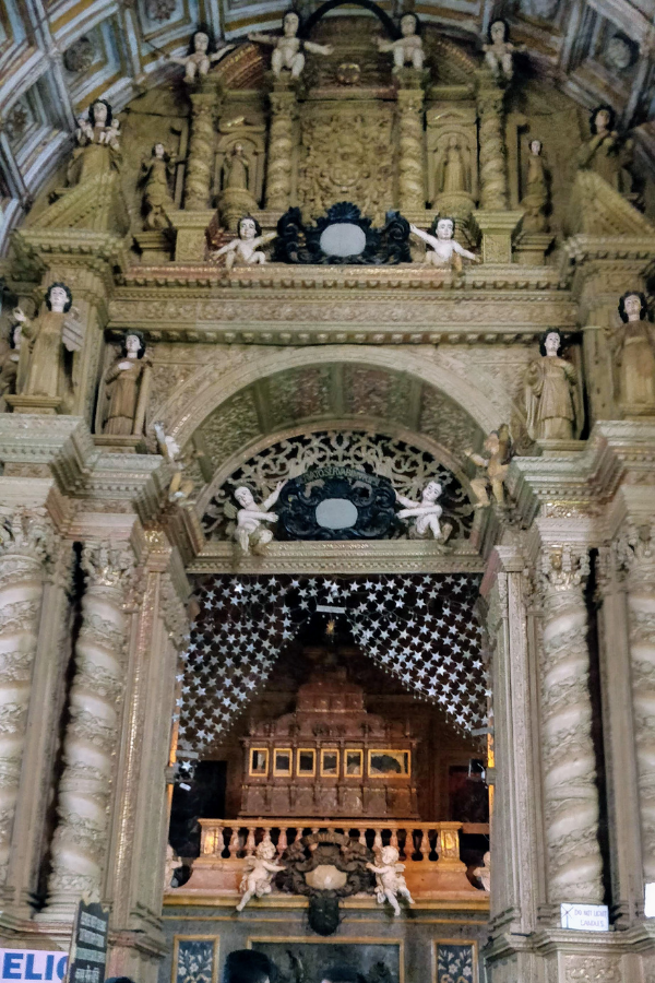 The sacred silver casket and ornate mausoleum housing the mortal remains of St. Francis Xavier inside the Basilica of Bom Jesus, showcasing Italian marble work and Hindu craftsmanship
