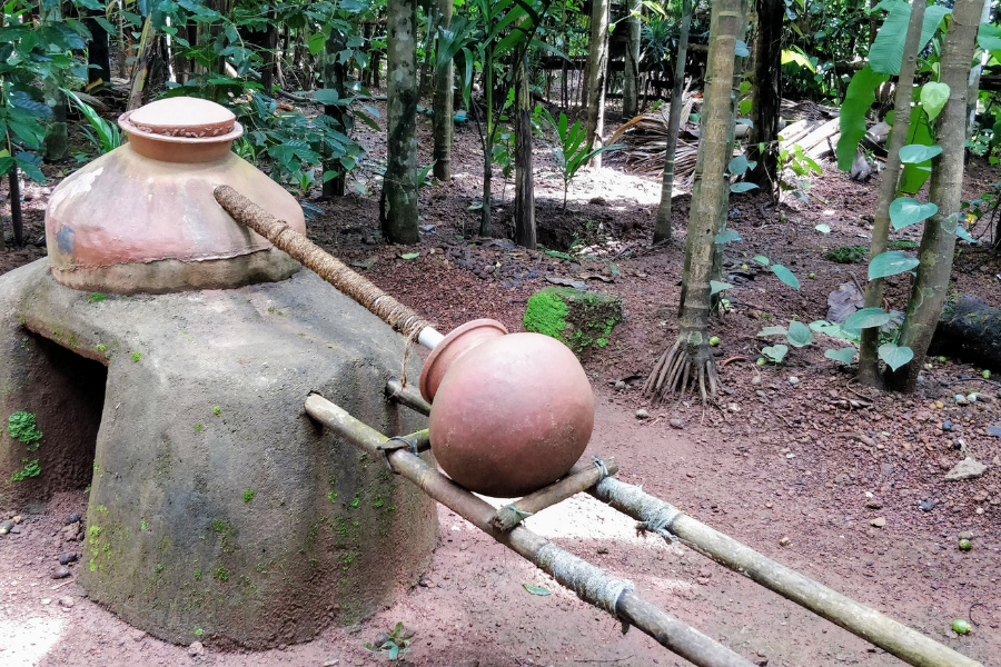 Traditional organic distillery at the spice plantation showing the equipment used to produce cashew feni, Goa's famous local tipple