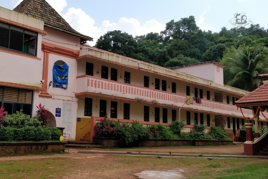 Interior courtyard of Shanta Durga Temple showing the traditional architecture, ornate pillars, and devotees offering prayers