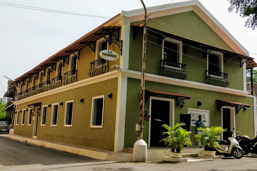Charming Portuguese colonial architecture in Fontainhas featuring vibrant painted facades, ornate balconies, artistic doors, and traditional window shutters