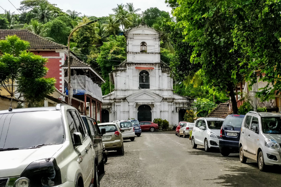 White-painted Chapel of St. Sebastian in Fontainhas with its simple facade, cross on top, and traditional Portuguese architectural elements