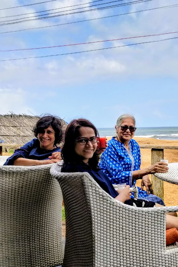 Breakfast setup by Candolim Beach with ocean views, showing the pleasant weather and beach lifestyle experience in Goa