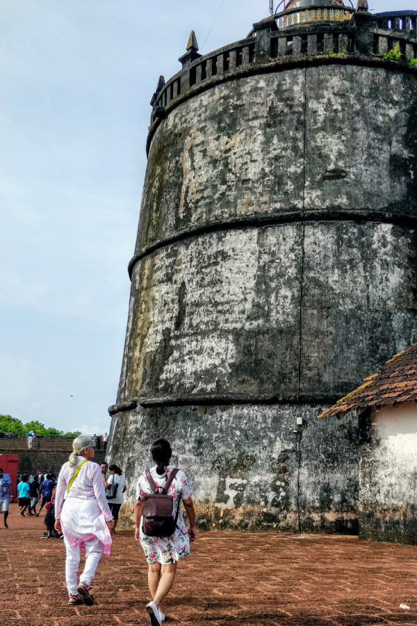 Fort Aguada perched on a hilltop overlooking the Arabian Sea showing the Portuguese colonial military architecture, ramparts, and the historic lighthouse structure
