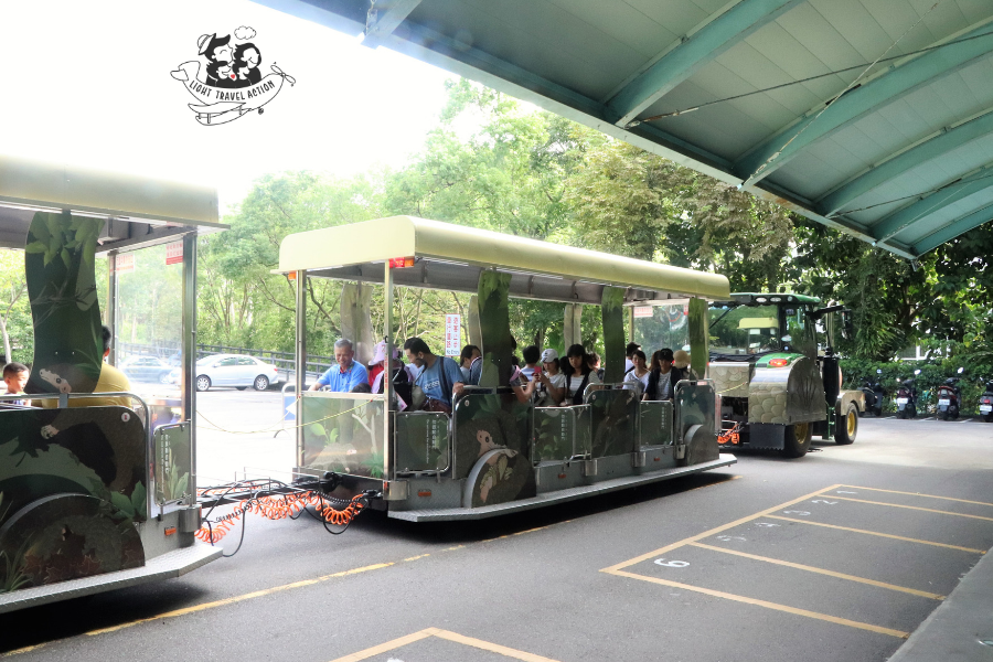 Colorful shuttle train at Taipei Zoo with bright painted exterior carrying passengers between exhibits for NT$5 per ride showing convenient transportation option